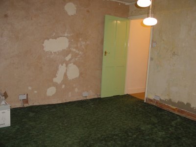 pic of bedroom with horrid bare plastered walls