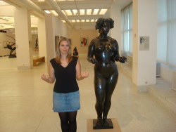 Chloe standing next to a statue